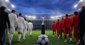 Dos equipos entran al campo, con un trofeo y un balón en primer plano